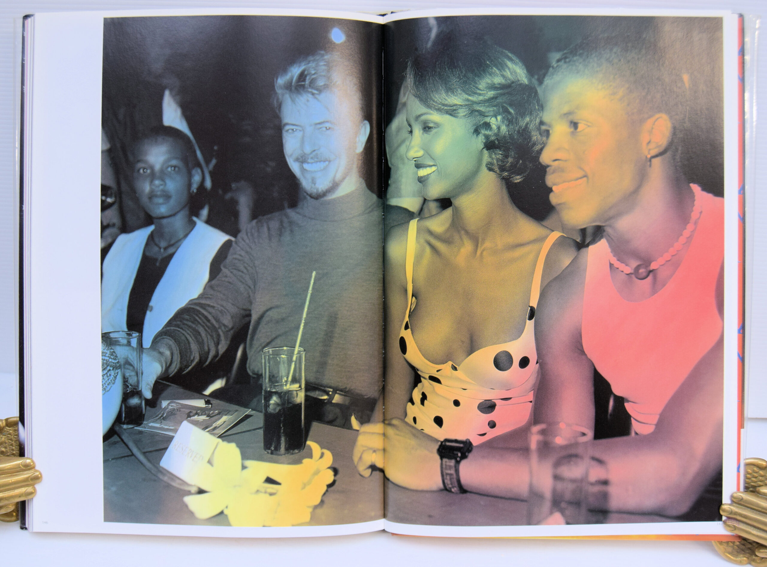 IMAN: Her first book is a gloriously entertaining hybrid essay on the cultural-cum-political power of good looks. A quarter century of the most famous photographs by Helmut Newton, Steven Meisel, Herb Ritts, Peter Lindbergh, Bruce Weber, Scavullo, David Bailey, Nick Knight, and many others are contextualized by well-known essayists, a chorus of celebrity contributions, and Iman's own take on her much-mythologized career. The book's outrageous pop design--by graphic designers Barnbrook Studios--makes it plain that this is not just one woman's success story. "I Am Iman" captures the funny, infuriating, and often absurd validation of black and ethnic looks in a beauty industry where billions of dollars--and the self-image of women everywhere--are on the line. Peeks behind the curtain and scintillating interviews are courtesy of feminist critic bell hooks, "Interview" editor Ingrid Sischy, model and manager Bethann Hardison, and such celebrities as Cindy Crawford, Yves St. Laurent, Naomi Campbell, Bruce Weber, Tyra Banks, and many more. With graphic design featuring gatefolds, diecuts, and other interactive elements, as well as specially commissioned, never-before-seen images by Annie Leibowitz, Ellen Von Unwerth, Sante D'Orazio, and Michel Comte, this book is an assemblage worthy of any fashionista's dream. - Image 3